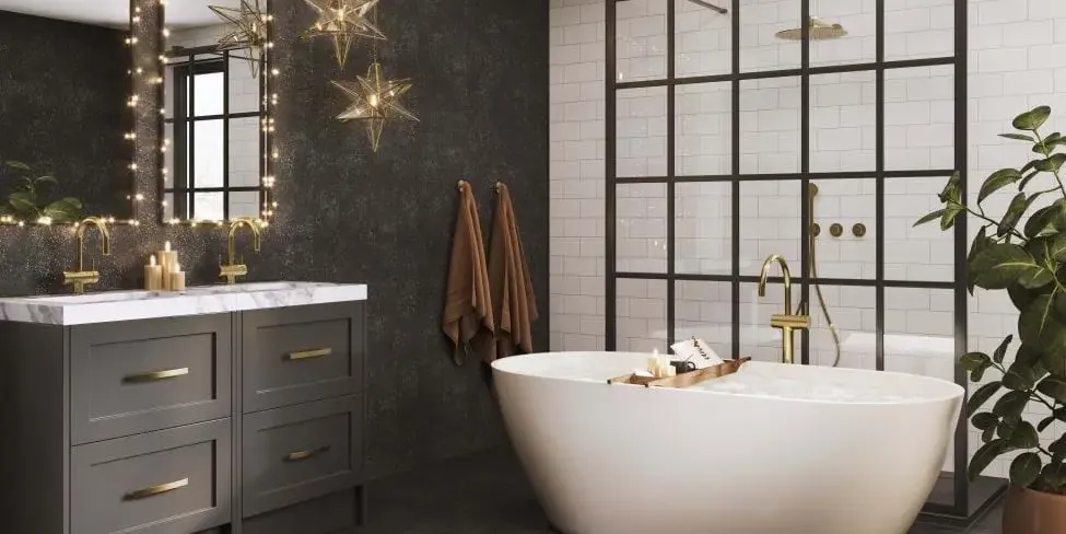 A bathroom with a freestanding bath and a wall in a dark stone finish