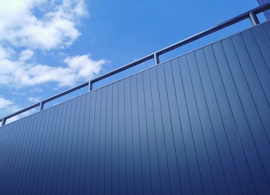 Graphitfarbene Aluminiumfassade vor dem Himmel