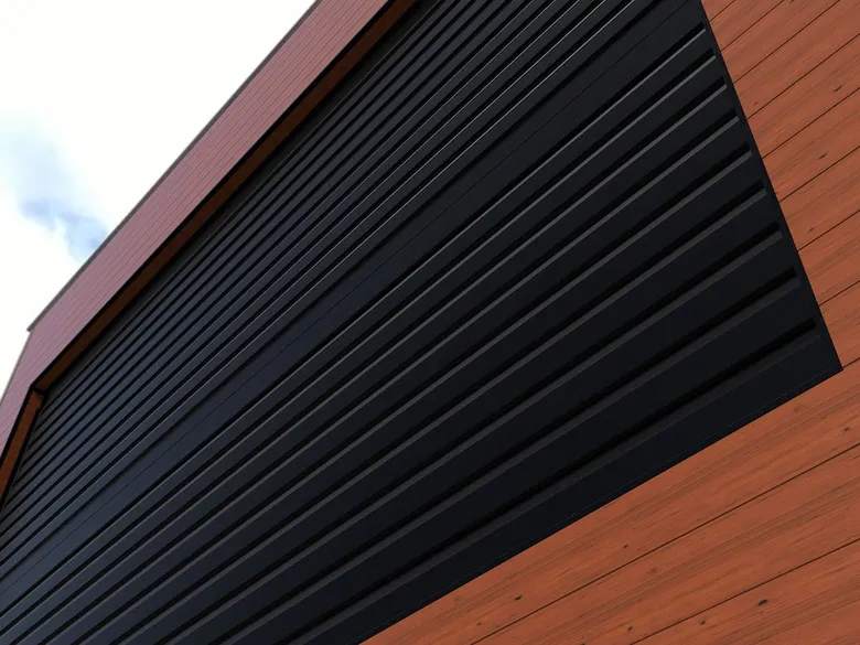 Detail einer Aluminiumfassade: schwarze und ziegelrote Paneele
