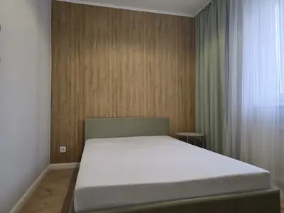 Pokój hotelowy, ściana za łóżkiem z paneli w dekorze dębu